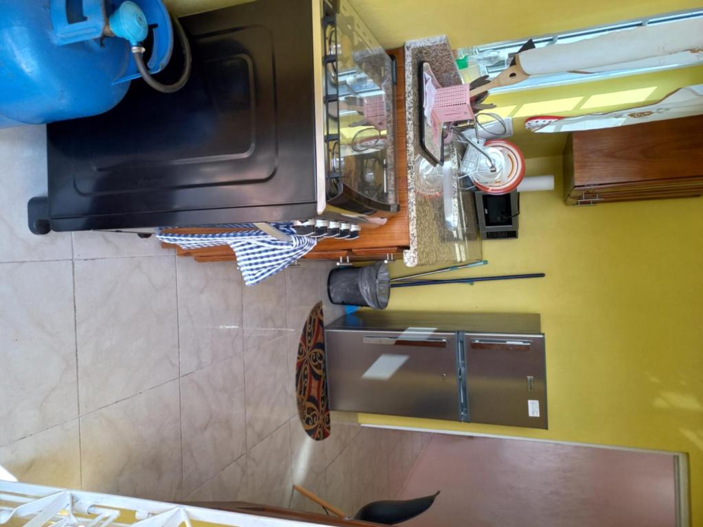 Kitchen cooking area with stove fridge and countertops